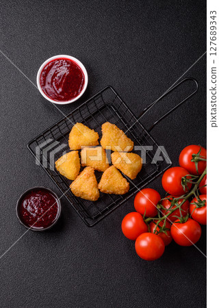 Fried mozzarella or brie cheese with cranberry or raspberry sauce Fried mozzarella or brie cheese with cranberry or raspberry sauce 127689343