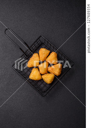 Fried mozzarella or brie cheese with cranberry or raspberry sauce 127689354