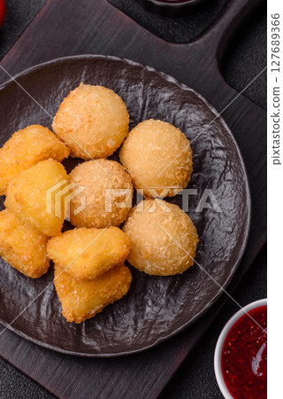 Fried mozzarella or brie cheese with cranberry or raspberry sauce Fried mozzarella or brie cheese with cranberry or raspberry sauce 127689366
