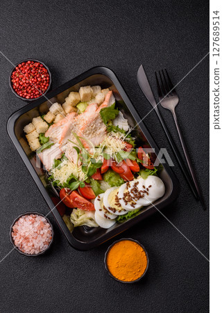 Bowl with caesar salad with chicken, parmesan cheese, tomatoes, croutons, lettuce leaves Bowl with caesar salad with chicken, parmesan cheese, tomatoes, croutons, lettuce leaves 127689514