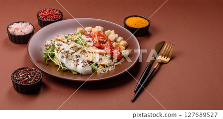 Bowl with caesar salad with chicken, parmesan cheese, tomatoes, croutons, lettuce leaves Bowl with caesar salad with chicken, parmesan cheese, tomatoes, croutons, lettuce leaves 127689527