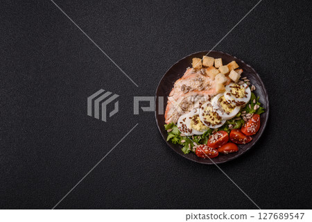 Bowl with caesar salad with chicken, parmesan cheese, tomatoes, croutons, lettuce leaves Bowl with caesar salad with chicken, parmesan cheese, tomatoes, croutons, lettuce leaves 127689547