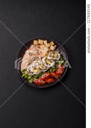 Bowl with caesar salad with chicken, parmesan cheese, tomatoes, croutons, lettuce leaves Bowl with caesar salad with chicken, parmesan cheese, tomatoes, croutons, lettuce leaves 127689548
