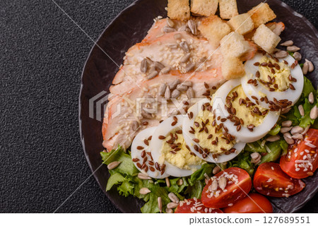 Bowl with caesar salad with chicken, parmesan cheese, tomatoes, croutons, lettuce leaves Bowl with caesar salad with chicken, parmesan cheese, tomatoes, croutons, lettuce leaves 127689551
