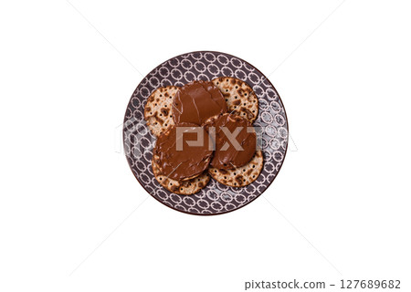 Matzah with chocolate paste for the Jewish holiday of passover Matzah with chocolate paste for the Jewish holiday of passover 127689682