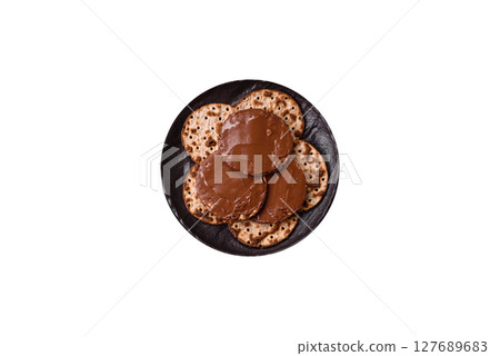 Matzah with chocolate paste for the Jewish holiday of passover Matzah with chocolate paste for the Jewish holiday of passover 127689683