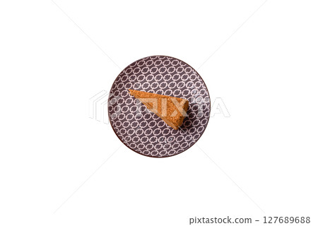 A slice of honey puff cake or pumpkin, carrot and cream pie, vegan sweets 127689688