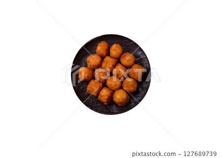 Cheese or potato croquettes, balls fried in breading with salt, spices Cheese or potato croquettes, balls fried in breading with salt, spices 127689739