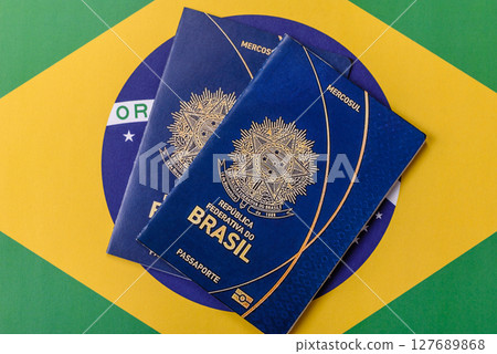 Brazilian passport against the background of the national flag of Brazil Brazilian passport against the background of the national flag of Brazil 127689868