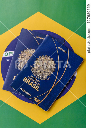 Brazilian passport against the background of the national flag of Brazil Brazilian passport against the background of the national flag of Brazil 127689869