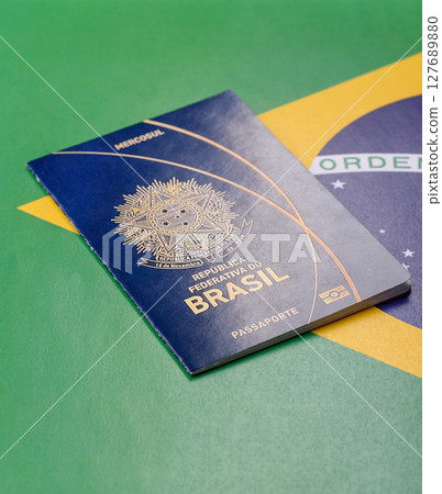 Brazilian passport against the background of the national flag of Brazil 127689880