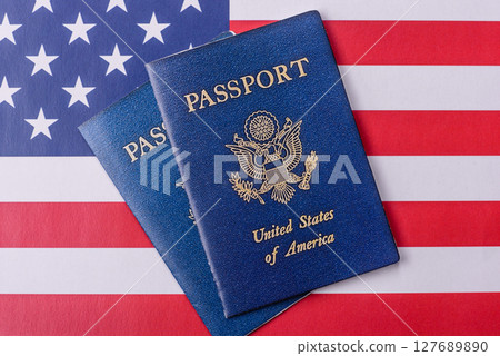 American passport against the background of the US national flag American passport against the background of the US national flag 127689890