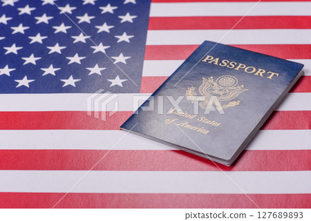 American passport against the background of the US national flag American passport against the background of the US national flag 127689893