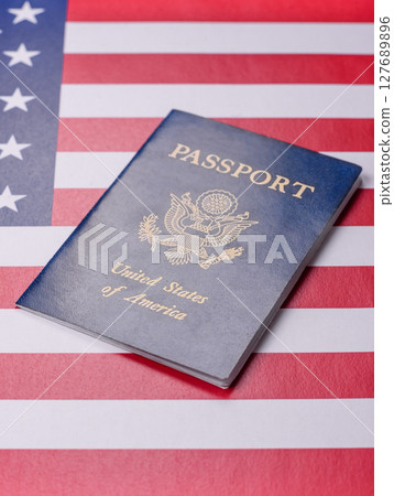 American passport against the background of the US national flag American passport against the background of the US national flag 127689896
