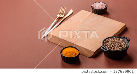 Empty wooden cutting board on a monochrome brown background 127689901