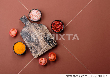 Empty wooden cutting board on a monochrome brown background Empty wooden cutting board on a monochrome brown background 127690014
