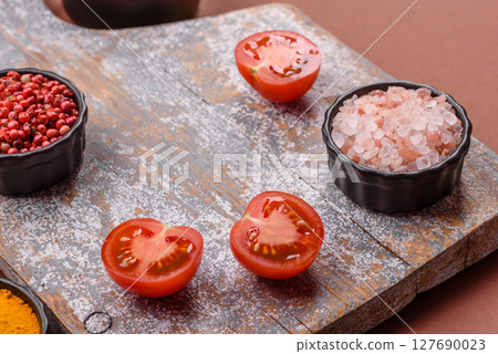 Empty wooden cutting board on a monochrome brown background 127690023