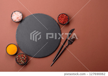 Empty ceramic plate on a monochrome brown background 127690062