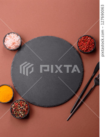 Empty ceramic plate on a monochrome brown background Empty ceramic plate on a monochrome brown background 127690063