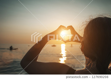 Heart Hands at Sunset Over the Sea Heart Hands at Sunset Over the Sea 127690208