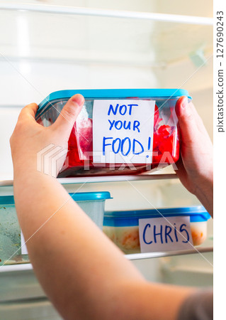 Dramatic and angry sticker on meal prep containers in work fridge. Great for office themed social media content, viral workplace trends and humor. 127690243
