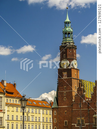 Historic Townhouse with Clock Under Clear Blue Sky, Wroclaw, Poland Historic Townhouse with Clock Under Clear Blue Sky, Wroclaw, Poland 127690321