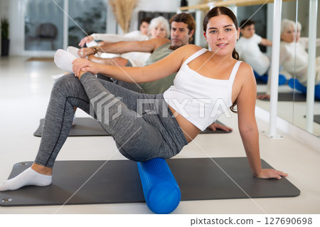 Portrait of people practicing Matsyendrasana known as Lord of Fishes Pose during group yoga training 127690698