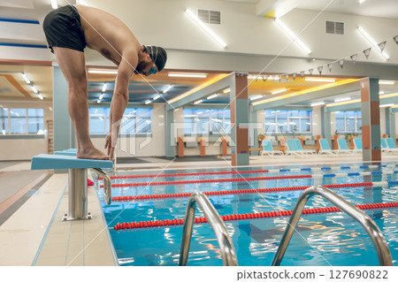 Man having a workout in the swimming pool Man having a workout in the swimming pool 127690822