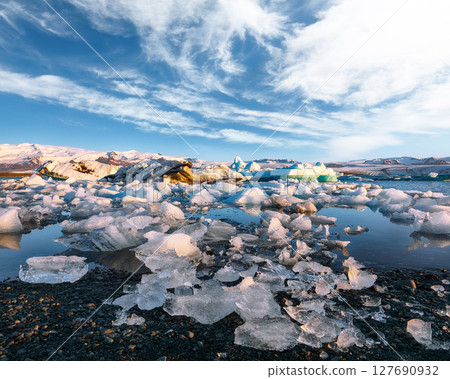 Ramarkable landscape with floating icebergs in Jokulsarlon glacier lagoon at sunset. Ramarkable landscape with floating icebergs in Jokulsarlon glacier lagoon at sunset. 127690932