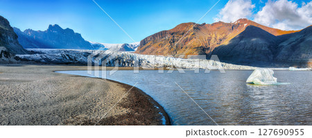 Impressive view of Skaftafellsjokull glacier tongue and volcanic mountains around on South Iceland. Impressive view of Skaftafellsjokull glacier tongue and volcanic mountains around on South Iceland. 127690955