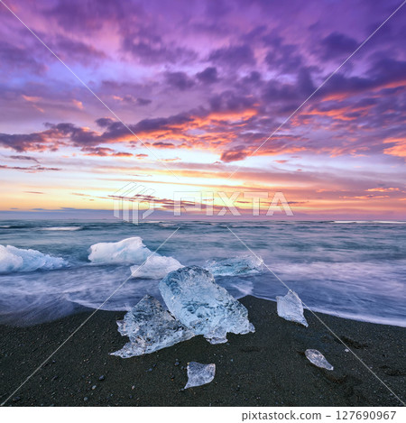 Impressive pieces of the iceberg sparkle on famous Diamond Beach at Jokulsarlon lagoon during sunset. Impressive pieces of the iceberg sparkle on famous Diamond Beach at Jokulsarlon lagoon during sunset. 127690967