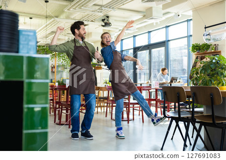 Man and woman waiters celebrating at restaurant 127691083