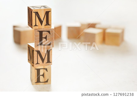 Four wooden cubes arranged in stack with word MEME on them, space for text / image at down right corner 127691238