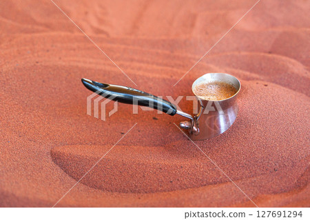 Coffee prepared on street in traditional Arabic way, cezve or ibrik (small Turkish coffe pot) is placed in red hot sand until liquid boils Coffee prepared on street in traditional Arabic way, cezve or ibrik (small Turkish coffe pot) is placed in red hot sand until liquid boils 127691294