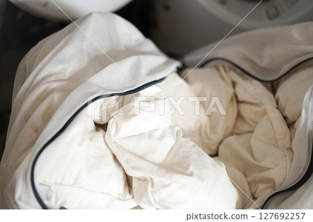 Washing a down comforter: Washing a down comforter in a laundry net Washing a down comforter: Washing a down comforter in a laundry net 127692257
