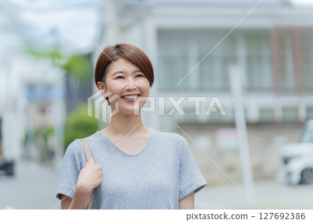 微笑的女人走在城市裡 127692386