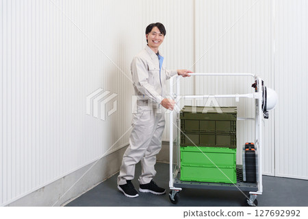 Full body of a male worker working in a warehouse 127692992