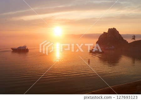Colorful sunset over Lake Baikal. View of the Khuzhir Bay near the Shaman rock. 127693123