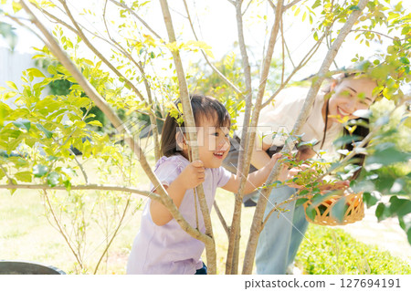 Girls playing around a tree Girls playing around a tree 127694191