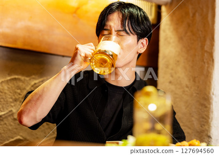 Male drinking beer Male drinking beer 127694560