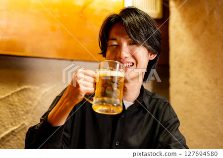 Male drinking beer 127694580
