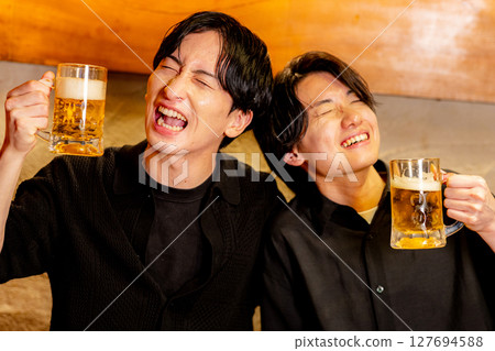 A man toasting at a pub 127694588