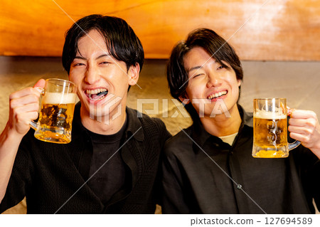 A man toasting at a pub 127694589