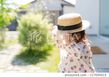 A girl wearing a straw hat A girl wearing a straw hat 127694814
