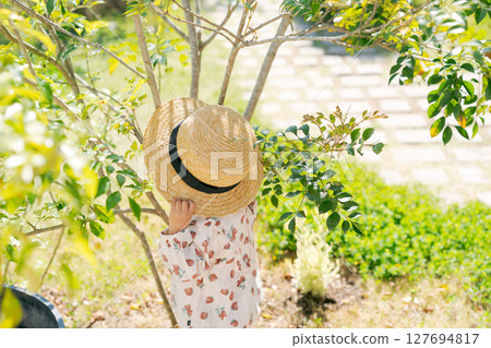 A girl wearing a straw hat A girl wearing a straw hat 127694817