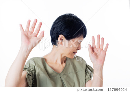 Middle-aged woman closing her eyes 127694924