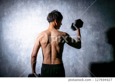 Men doing muscle training with dumbbells 127694927