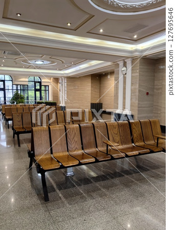 wooden seating arrangement in modern waiting area during daylight hours. closeup. wooden seating arrangement in modern waiting area during daylight hours. closeup. 127695646