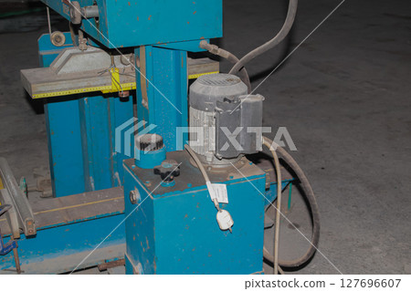Detail view of industrial hydraulic power unit with electric motor and controls 127696607