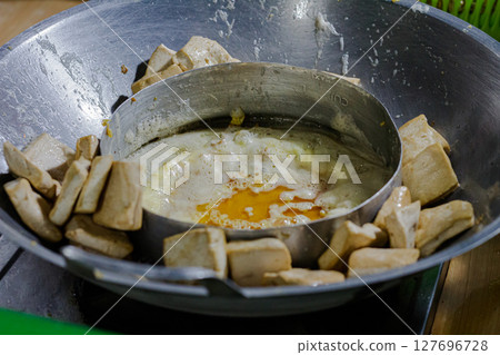 Cooking Process of Frying Tofu Pieces and Egg in a Traditional Wok Cooking Process of Frying Tofu Pieces and Egg in a Traditional Wok 127696728